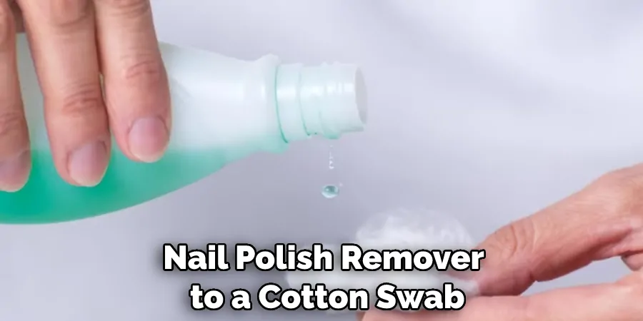 Nail Polish Remover to a Cotton Swab