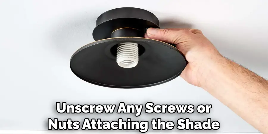 Unscrew Any Screws or Nuts Attaching the Shade