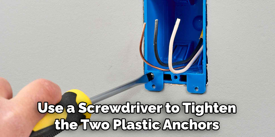 Use a Screwdriver to Tighten the Two Plastic Anchors