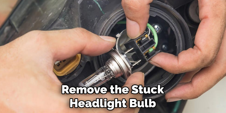 remove the stuck headlight bulb
