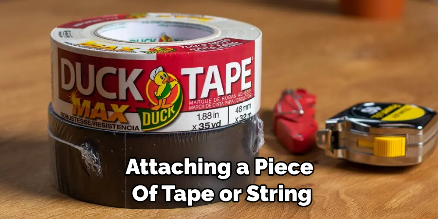 Attaching a Piece of Tape or String