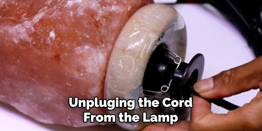 Unpluging the Cord From the Lamp