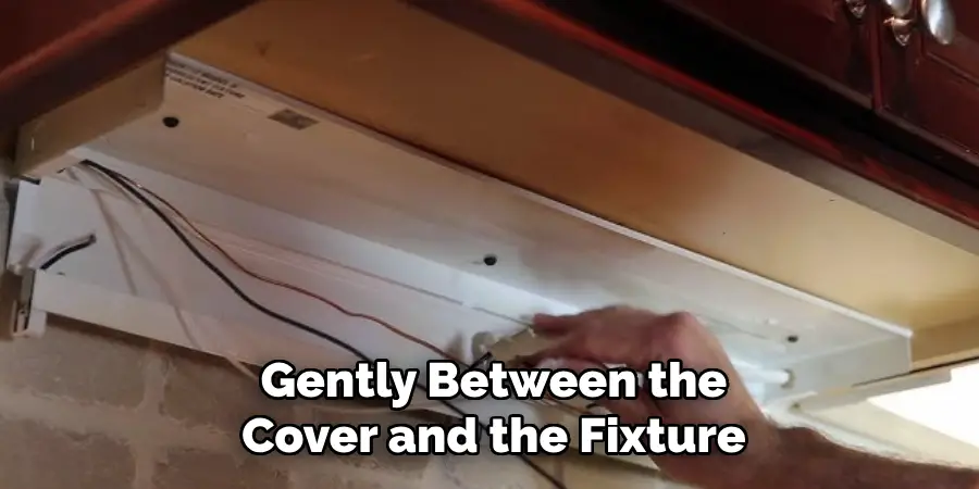 Gently Between the
Cover and the Fixture