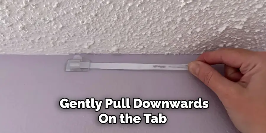 Gently Pull Downwards On the Tab
