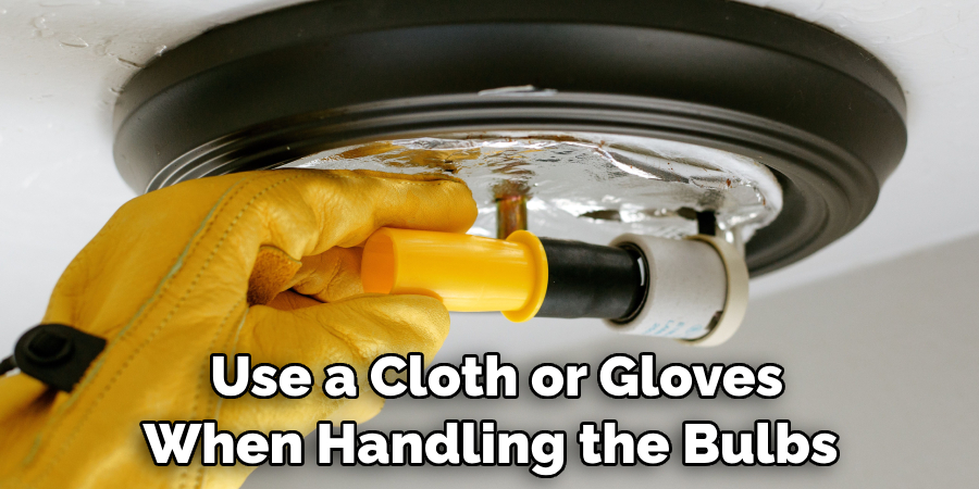  Use a Cloth or Gloves When Handling the Bulbs